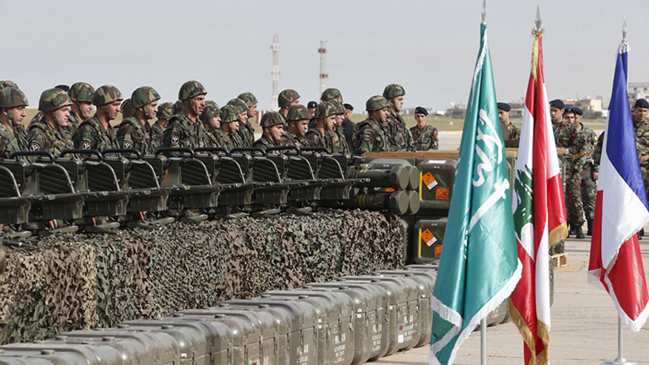 MIDEAST-CRISIS/LEBANON-ARMY Lebanese army soldiers stand next to displayed weapons that they received during a ceremony at Beirut airport airbase April 20, 2015. The first shipment of French weapons and military equipment arrived in Lebanon on Monday under a Saudi-funded deal worth $3 billion to bolster the Lebanese army's fight against militants encroaching from neighboring Syria. (From L to R) The national flags of Saudi Arabia, Lebanon and France are displayed during the ceremony. REUTERS/Mohamed Azakir - RTX19H2B