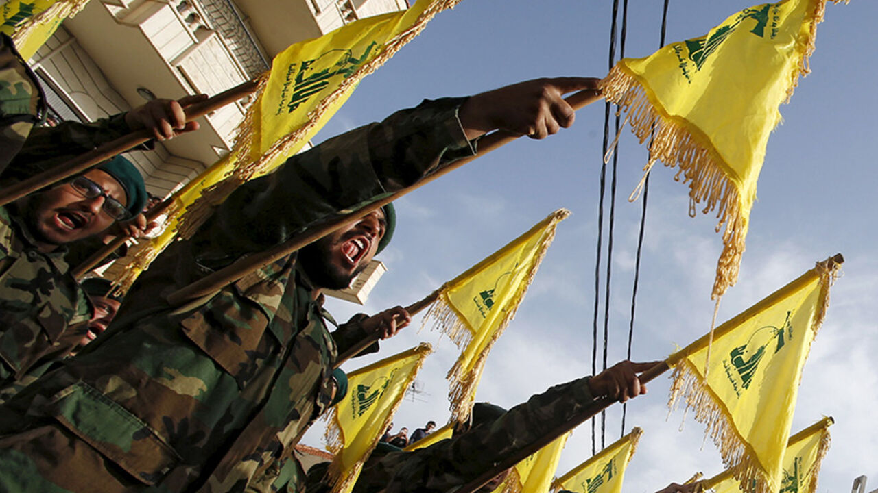MIDEAST-CRISIS/HEZBOLLAH Lebanon's Hezbollah members carry Hezbollah flags during the funeral of their fellow fighter Adnan Siblini, who was killed while fighting against insurgents in the Qalamoun region, in al-Ghaziyeh village, southern Lebanon May 26, 2015. Hezbollah is fighting across all of Syria alongside the army of Syria's President Bashar al-Assad and is willing to increase its presence there when needed, the leader of the Lebanese Shi'ite movement said on Sunday. REUTERS/Ali Hashisho - RTX1EN4E