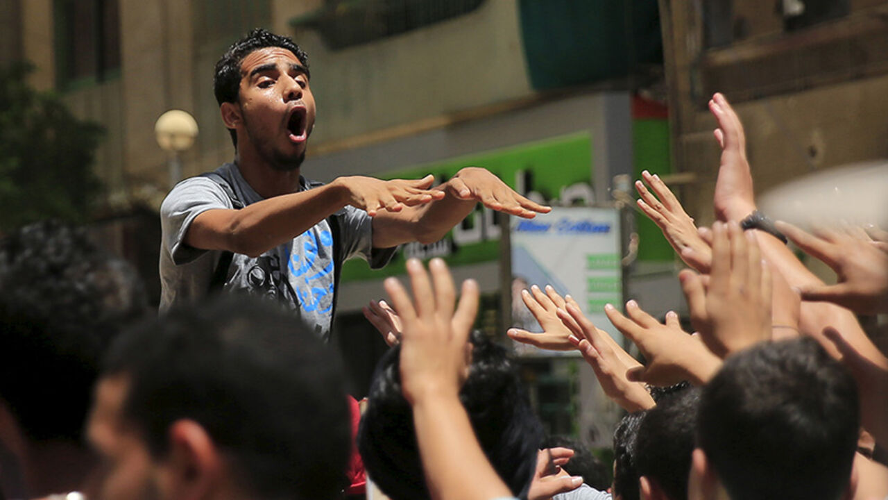 EGYPT-MURSI/ A supporter of the Muslim Brotherhood and deposed Egyptian President Mohamed Mursi shouts slogans against an Egyptian court's decision to sentence Mursi and other leaders to death, at a rally in Al Haram street near Giza square, south of Cairo, Egypt June 19, 2015. Mursi will appeal against a conviction for violence, kidnapping and torture imposed by a court over the killing of protesters, his lawyers were quoted as saying by state media on Thursday. REUTERS/Amr Abdallah Dalsh - RTX1H9EE