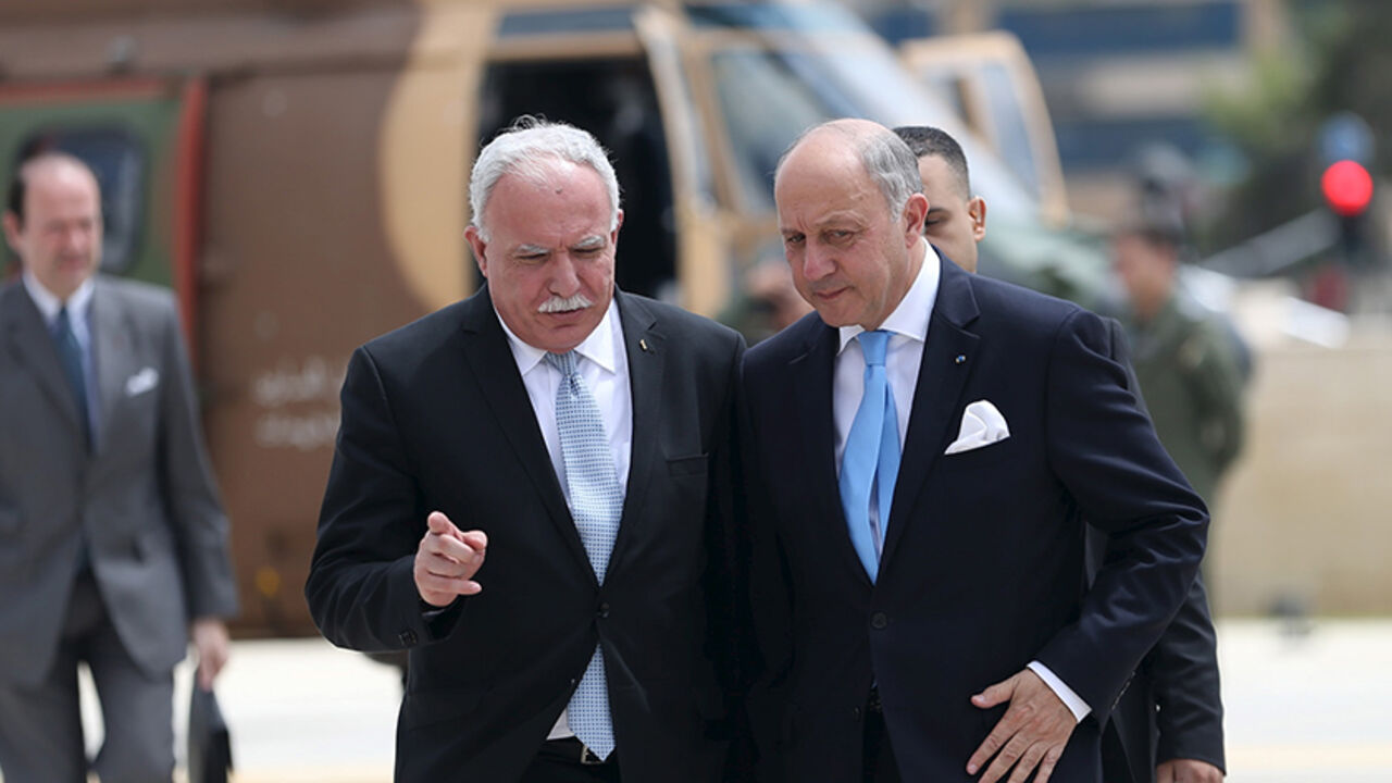 ISRAEL-PALESTINIANS/FRANCE France's Foreign Minister Laurent Fabius (R) is welcomed by Palestinian Foreign Minister Riyad al-Maliki upon Fabius' arrival at the West Bank city of Ramallah June 21, 2015. Prime Minister Benjamin Netanyahu prefaced talks about a French-led peace initiative on Sunday by saying foreign powers were trying to dictate to Israel a deal with the Palestinians. Fabius, on a two-day visit to the Middle East, was due to meet Palestinian leaders in the occupied West Bank before seeing Netanyahu later in the day. REU