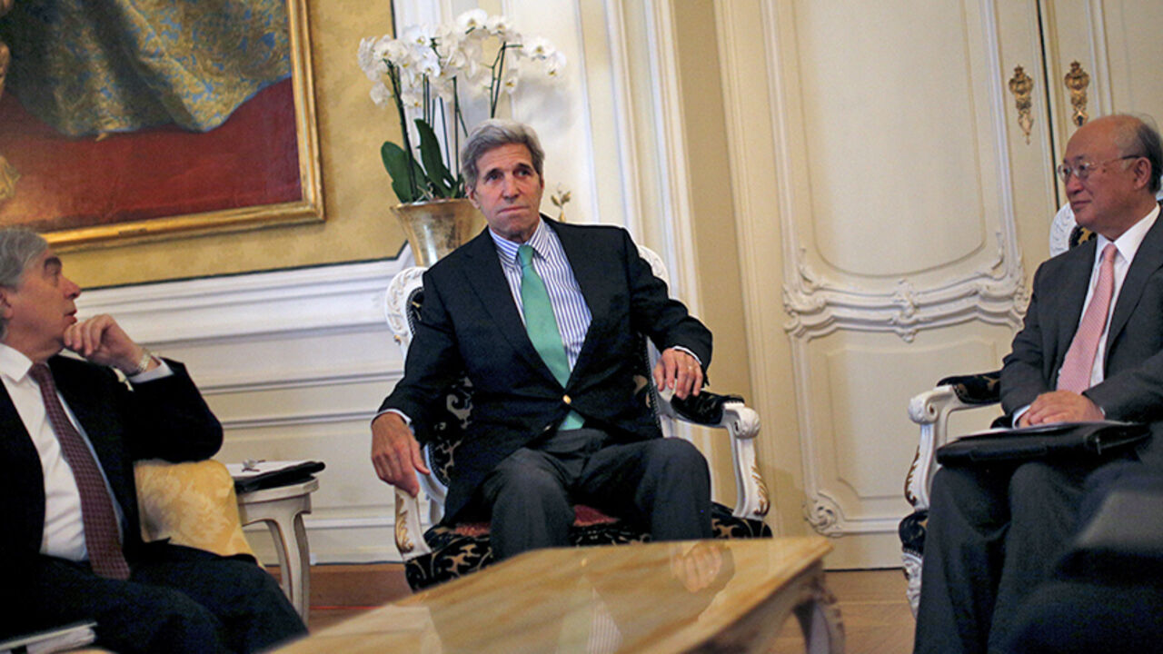 IRAN-NUCLEAR/ U.S. Secretary of State John Kerry sits between U.S. Secretary of Energy Ernest Moniz (L) and Atomic Energy Agency (IAEA) Director General Yukiya Amano during a meeting at a hotel in Vienna, Austria June 29, 2015. Iran is backtracking from an interim nuclear agreement with world powers three months ago, Western officials suggested on Sunday, as U.S. and Iranian officials said talks on a final accord would likely run past a June 30 deadline. REUTERS/Carlos Barria - RTX1I8AB