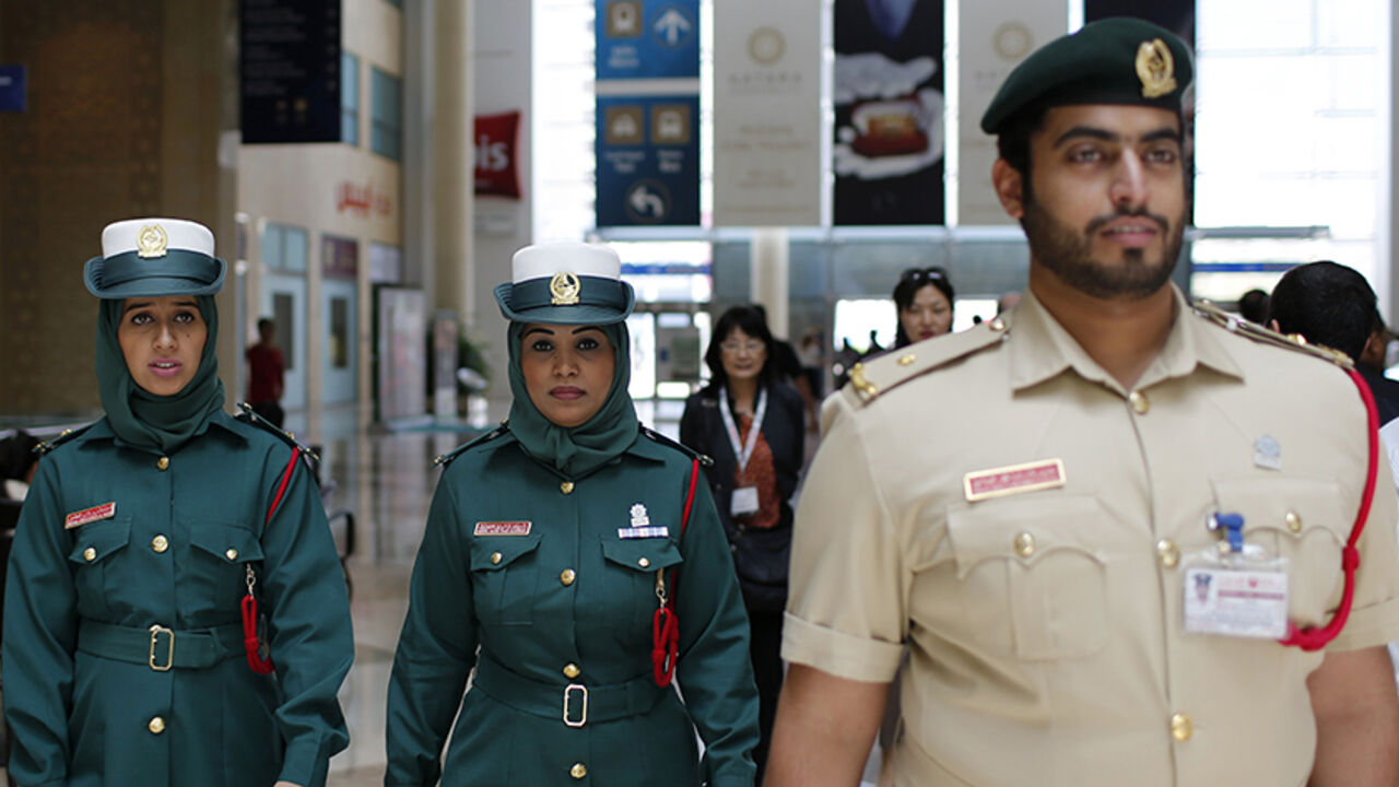 DUBAI/ Police officers walk during the Arabian Travel Market exhibition in Dubai May 6, 2013. REUTERS/Ahmed Jadallah (UNITED ARAB EMIRATES - Tags: CRIME LAW TRAVEL BUSINESS) - RTXZCAO