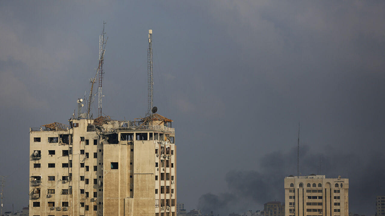 Veiw of the media complex (L) that houses the offices of Hamas-run Al Aqsa television and radio after it was targeted in an Israeli strike in central Gaza City early on July 29, 2014.  Israeli aircraft, tanks and navy gunboats pounded symbols of Hamas control in Gaza City in the heaviest night of bombardment in three weeks of Israel-Hamas fighting.  AFP PHOTO / MOHAMMED ABED        (Photo credit should read MOHAMMED ABED/AFP/Getty Images)
