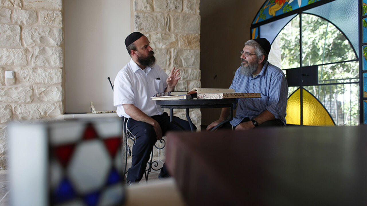 TOURISM-ISRAEL/KABBALAH Eyal Riess (L) from the International Center for Tzfat Kabbalah and artist Michael Chouraqui study religious texts together in the northern town of Safed May 26, 2010. Safed -- also known as Tzfat -- is where the tourism boom Israel is enjoying with a lull in violence comes with a spiritual twist, thanks in part to the interest the Queen of Pop takes in Jewish Kabbalah mysticism, which has roots in the town. To match Reuters Life! TOURISM-ISRAEL/KABBALAH.
REUTERS/Nir Elias (ISRAEL - Tags: TRAVEL SOCIETY RE