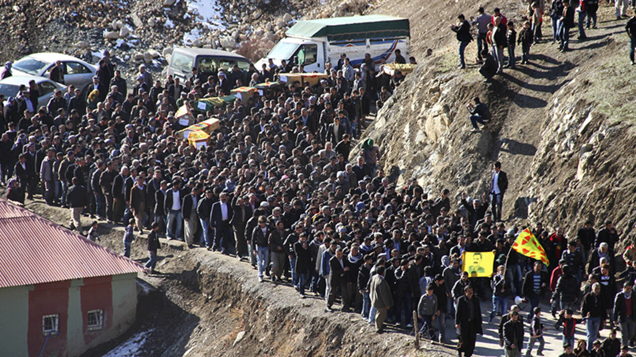 Coffins of victims killed in air strikes are carried by villagers during a funeral ceremony in Gulyazi near the southeastern Turkish town of Uludere, in Sirnak province, December 30, 2011. Turkish rights groups called on Friday for a U.N.-sponsored investigation after Turkish warplanes killed 35 villagers in an airstrike targeting Kurdish rebels on the Iraqi border that the government has called an operational mistake. REUTERS/Stringer (TURKEY - Tags: POLITICS) - RTR2VQMB
