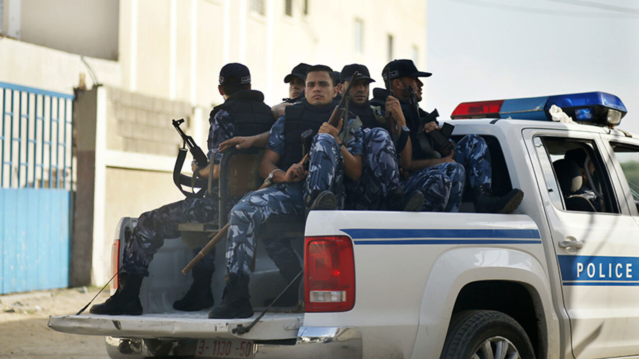 PALESTINIANS-HAMAS/COURT Hamas policemen guard outside a Gaza military court September 17, 2012. The court on Monday handed out rulings against four Palestinians involved in the kidnapping and killing of an Italian pro-Palestinian activist, Vittorio Arrigoni, in 2011, sentencing two of them to life imprisonment, witnesses said. Of the remaining two, one was sentenced to 10 years and the other one year in prison. REUTERS/Mohammed Salem (GAZA - Tags: POLITICS CRIME LAW) - RTR382IQ