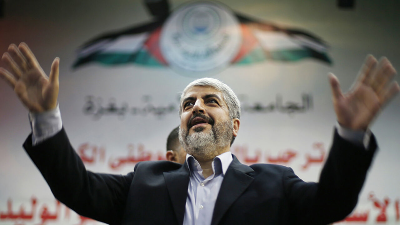 Hamas chief Khaled Meshaal waves to Palestinian student during his visit to the Islamic University in Gaza City December 9, 2012. Hamas's vow to vanquish Israel after claiming "victory" in last month's Gaza conflict vindicates Israel's reluctance to relinquish more land to the Palestinians, Prime Minister Benjamin Netanyahu said on Sunday. Khaled Meshaal, the leader of the Islamist Hamas movement, made a defiant speech before thousands of supporters in the Gaza Strip on Saturday, promising to take "inch-by-