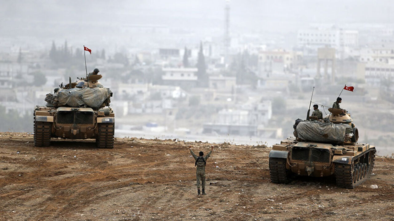 MIDEAST-CRISIS/TURKEY-KURDS Turkish army tanks take position on top of a hill near Mursitpinar border crossing in the southeastern Turkish town of Suruc in Sanliurfa province October 11, 2014. A senior Kurdish militant has threatened Turkey with a new Kurdish revolt if it sticks with its current policy of non-intervention in the battle for the Syrian town of Kobani. Kurdish forces allied to the Kurdistan Workers' Party (PKK), the People's Defence Units (YPG), are fighting against Islamic State insurgents attacking Kobani close to the