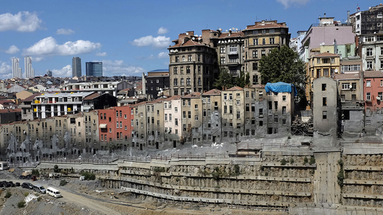 TURKEY-GENTRIFICATION/ Workers, with emptied old buildings in the background, pause at a construction site at Beyoglu district in central Istanbul August 29, 2014. The Turkish Parliament amended the commercial code to allow landlords to eject tenants of 10 years or more without cause. The rule, which went into effect in July, scraps a tradition of renter-friendly laws, potentially hitting millions of businesses and residents Picture taken August 29, 2014. To match TURKEY-GENTRIFICATION/ REUTERS/Murad Sezer (TURKEY - Tags: BUSINES