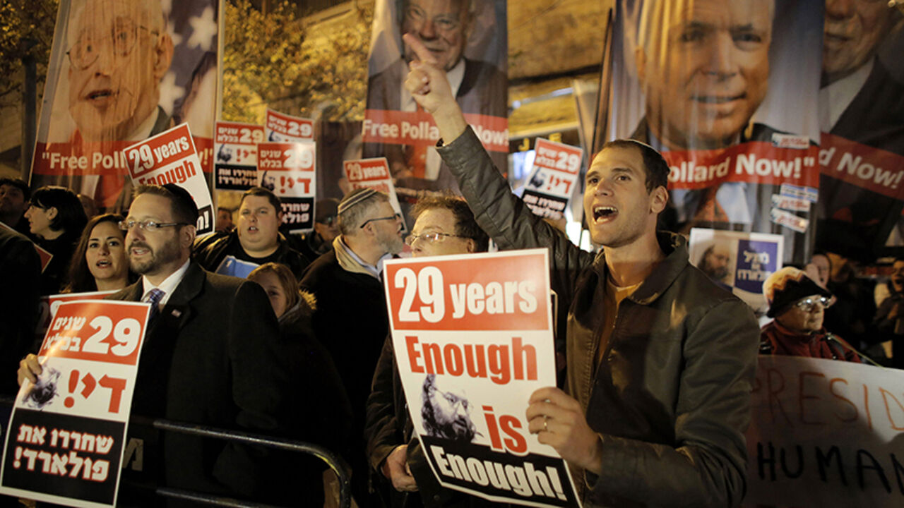 ISRAEL-PALESTINIANS/KERRY Israelis hold placards during a protest calling for the release of Jonathan Pollard from a U.S. prison, outside U.S. Secretary of State John Kerry's hotel in Jerusalem January 2, 2014. Kerry began his 10th visit to the region on Thursday in pursuit of an Israeli-Palestinian peace deal. Pollard, a former U.S. Navy intelligence analyst, has been serving a life sentence in the United States since he was caught spying for Israel in the 1980s. REUTERS/Ammar Awad (JERUSALEM - Tags: POLITICS CIVIL UNREST) - RTX170