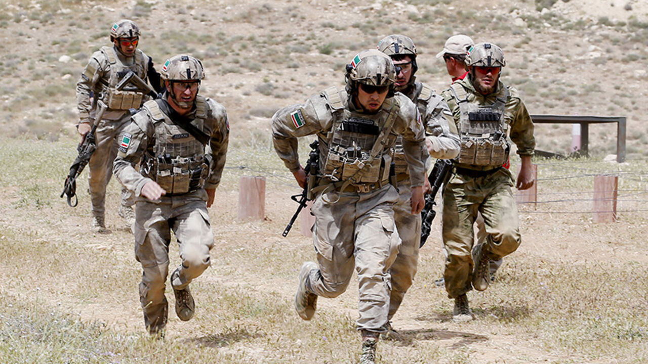 JORDAN-MILITARY/ Chechen soldiers, representing Russia and wearing uniforms stitched with Chechen flags, compete in the 7th Annual Warrior Competition at the King Abdullah Special Operations Training Center in Amman April 22, 2015. Thirty-eight teams from 18 countries are participating in the competition to test their military skills. REUTERS/Muhammad Hamed - RTX19UI0