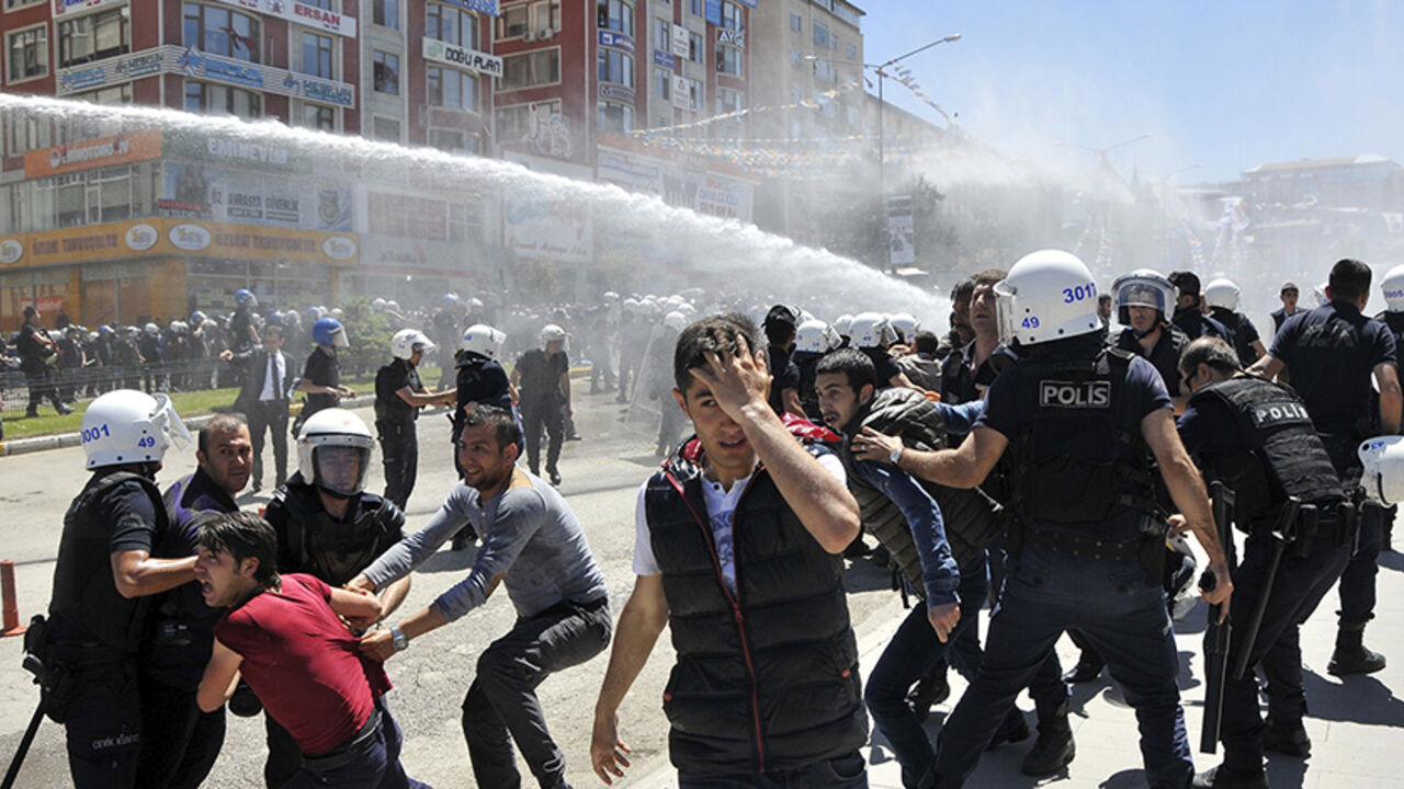 TURKEY-ELECTION/KURDS Riot police try to stop protesters in the eastern city of Erzurum, Turkey, June 4, 2015. Turkish police fired tear gas and water cannon to disperse crowds protesting against a rally by the pro-Kurdish Peoples' Democratic Party (HDP) in eastern Turkey on Thursday, ahead of weekend parliamentary elections. The clashes are the latest in a series of incidents to mar campaigning in the run-up to Sunday's highly charged vote, in which the HDP is hoping to deal a heavy blow to President Tayyip Erdogan's hopes of a