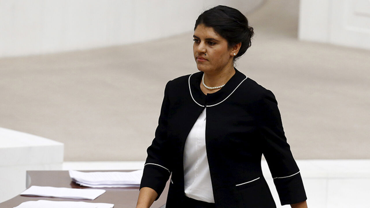 TURKEY-OCALAN/ Lawmaker of the pro-Kurdish Peoples' Democratic Party (HDP) Dilek Ocalan, niece of jailed Kurdistan Workers' Party (PKK) leader Abdullah Ocalan, returns to her seat after taking her oath at the Turkish parliament in Ankara, Turkey, June 23, 2015. For many Turks, the name Ocalan is indelibly linked to the man they revile as leader of a Kurdish insurgency in which 40,000 people died. But on Tuesday, an Ocalan became one of the country's youngest parliamentarians. Dilek, the 28-year-old niece of jailed militan