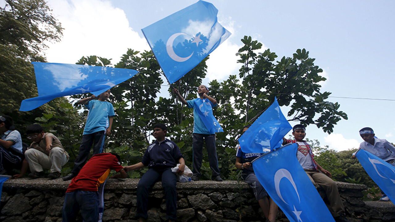 CHINA-TURKEY/ Boys wave East Turkestan flags during a protest against China near the Chinese Consulate in Istanbul, Turkey, July 5, 2015. China warned its citizens travelling in Turkey to be careful of anti-Beijing protests, warning them that some Chinese tourists have recently been "attacked and disturbed". The notice, posted on the Ministry of Foreign Affairs website on Sunday, said that there have recently been "multiple" demonstrations in Turkey targeting the Chinese government. The notice gave no details regarding t