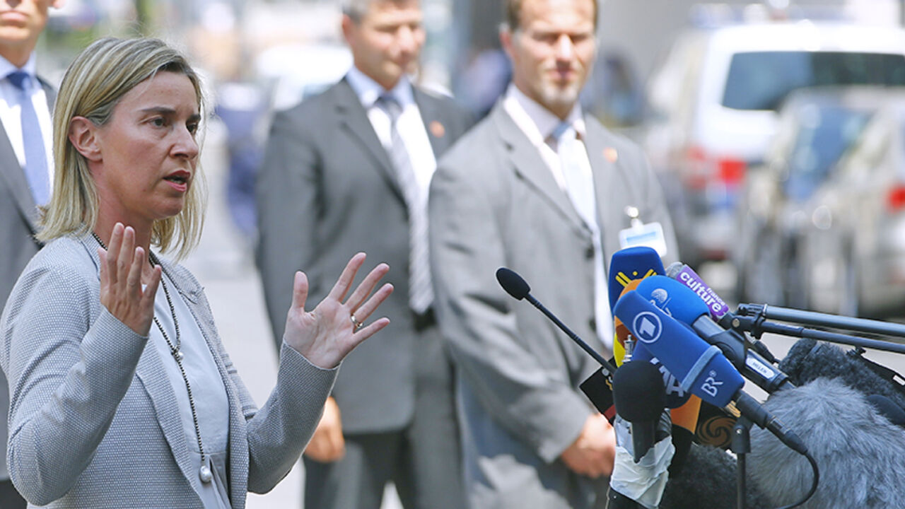 IRAN-NUCLEAR/EU European Union foreign policy chief Federica Mogherini talks to journalists outside Palais Coburg, the venue for nuclear talks in Vienna, Austria, July 7, 2015. Iran and major powers will continue negotiations on an historic nuclear deal past a deadline for a long-term agreement, which is set to expire later on Tuesday, Mogherini said. "We are continuing to negotiate for the next couple of days. This does not mean we are extending our deadline," Mogherini told reporters. REUTERS/Leonhard Foeger - RTX1JDO3
