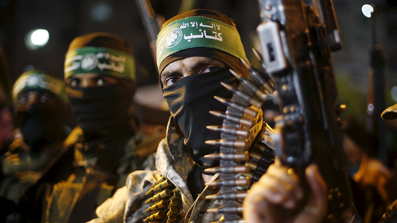 ISRAEL-PALESTINIANS/GAZA Palestinians Hamas militants march during an anti-Israel rally in Gaza City July 8, 2015. July 8th marks the one-year anniversary of the war between Israel and Hamas in Gaza. The 50-day conflict began after Israel said it was determined to put an end to constant rocket-fire from Gaza, launching an intense air and ground assault to do so. It was the third major conflict between Israel and Hamas militants since the Islamist group seized control of Gaza in 2007. The fighting killed more than 2,100 Palestinians
