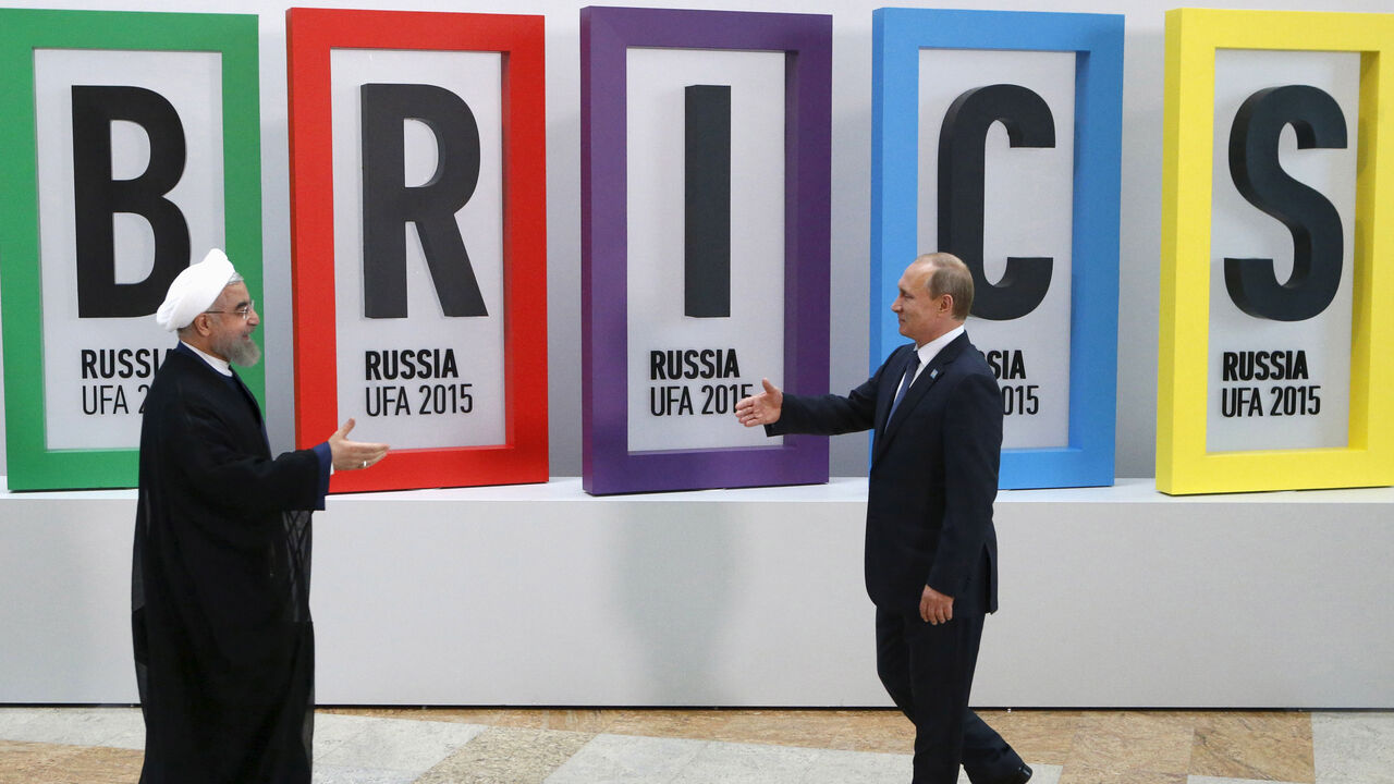 IRAN-NUCLEAR/ROUHANI-RUSSIA Russian President Vladimir Putin (R) greets Iran's President Hassan Rouhani in Ufa, Russia, July 9, 2015. Rouhani said on Thursday he was grateful to Russia for its efforts to secure an agreement at talks between six major powers and Iran on Tehran's nuclear program. REUTERS/Sergei Karpukhin TPX IMAGES OF THE DAY - RTX1JQOA