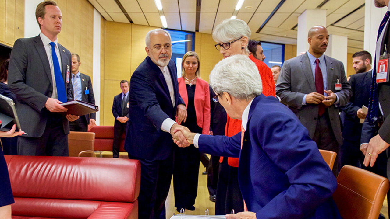 IRAN-NUCLEAR/ U.S. Secretary of State John Kerry (seated) shakes hands with Iranian Foreign Minister Javad Zarif as he prepares to leave the Austria Center in Vienna, Austria, July 14, 2015. Iran and six major world powers reached a nuclear deal on Tuesday, capping more than a decade of on-off negotiations with an agreement that could potentially transform the Middle East, and which Israel called an "historic surrender". REUTERS/US State Department/Handout via Reuters ATTENTION EDITORS - FOR EDITORIAL USE ONLY. NOT FOR S