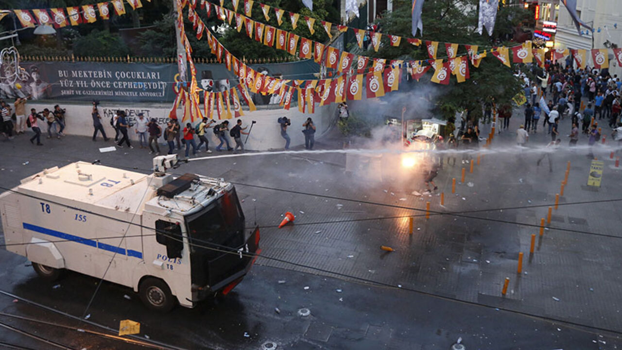 MIDEAST-CRISIS/TURKEY-PROTEST Riot police use water cannon as demonstrators throw fireworks during a protest in central Istanbul, Turkey, July 20, 2015. Police in Istanbul fired teargas and water cannon when a demonstration by protesters blaming the government for a suspected Islamic State suicide bombing turned violent, a Reuters witness said. Hundreds gathered near Istanbul's central Taksim Square after the bombing in the mostly Kurdish border town of Suruc which killed at least 30 people. Some chanted slogans against President Tayyip