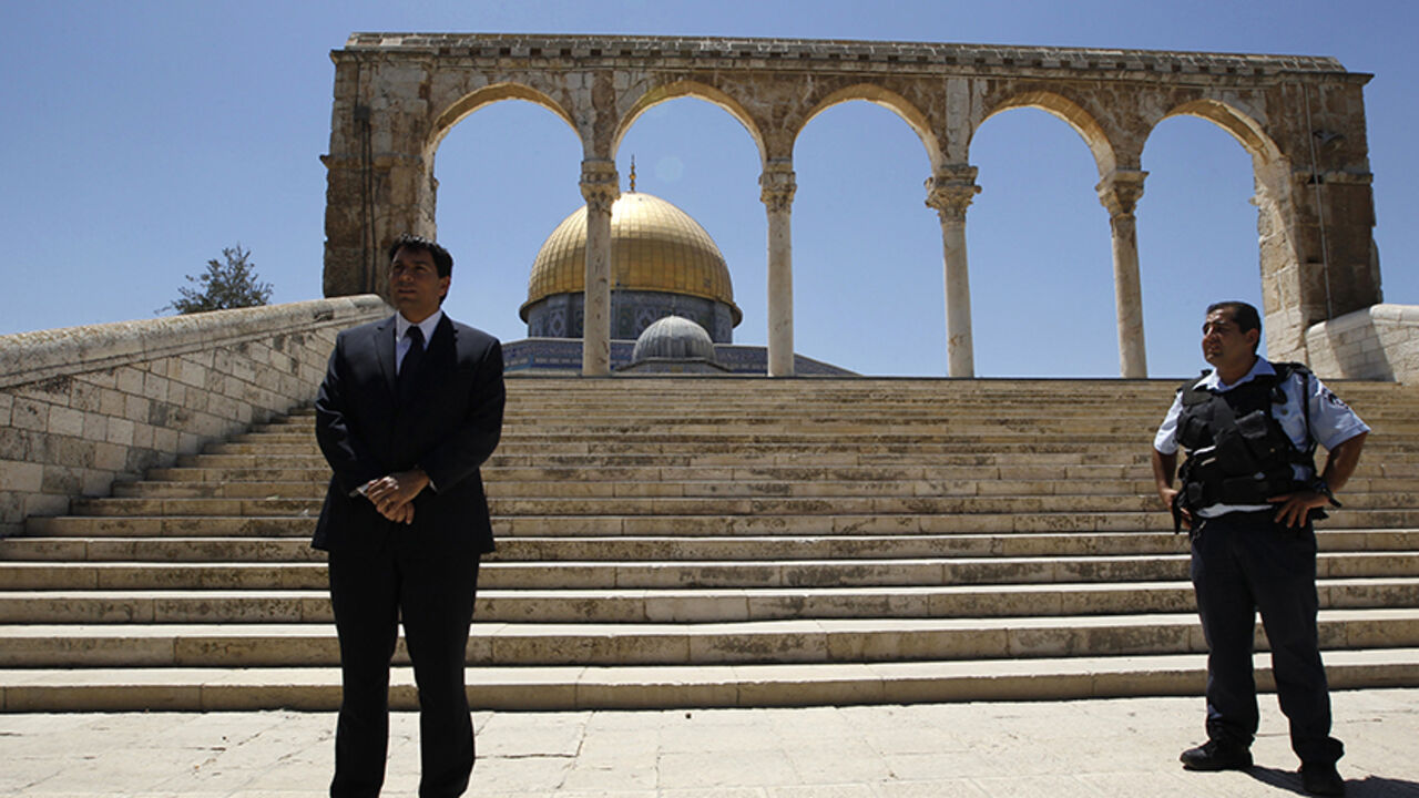 PALESTINIANS-ISRAEL/JERUSALEM Israeli lawmaker Danny Danon (L), a deputy parliament speaker, stands near an Israeli police officer in front of the Dome of the Rock on the compound known to Muslims as al-Haram al-Sharif and to Jews as Temple Mount, in Jerusalem's Old City July 20, 2010. Danon, a lawmaker of Prime Minister Benjamin Netanyahu's right-wing party, on Tuesday visited the flashpoint religious site in Jerusalem revered by Jews and Muslims, a move that has sparked violence in the past. REUTERS/Ammar Awad (JERUSALEM - Tags: POLIT