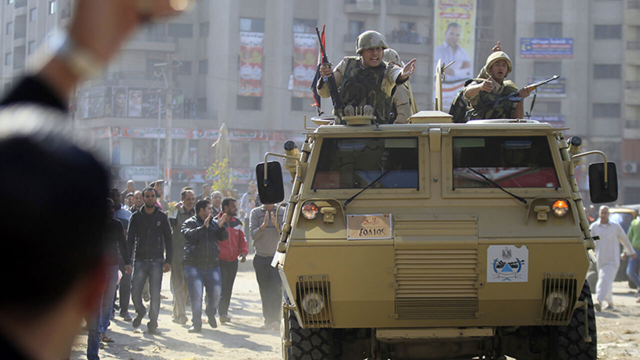 EGYPT-SECURITY/GENERAL Army soldiers take their positions with their armoured personnel vehicles during clashes with supporters of Muslim Brotherhood and ousted Egyptian President Mohamed Mursi in the Cairo suburb of Matariya November 28, 2014. Two people including an army general were killed and 25 were wounded on Friday in a drive-by shooting and clashes that erupted during Islamist protests around Egypt called by hardline Salafi group, the Salafi Front, security sources and health officials said. REUTERS/Mohamed Abd El Ghany (