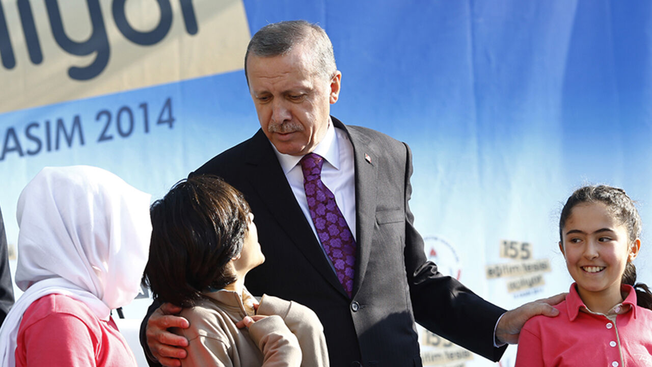 TURKEY-EDUCATION/ Turkey's President Tayyip Erdogan talks with students of Tevfik Ileri Imam Hatip School during its opening ceremony in Ankara November 18, 2014. Turkey has seen a sharp rise in religious schooling under reforms which Erdogan casts as a defence against moral decay, but which opponents see as an unwanted drive to shape a more Islamic nation. Almost a million students are enrolled in "imam hatip" schools this year, up from just 65,000 in 2002 when Erdogan's Islamist-rooted AK Party first came to power, he told
