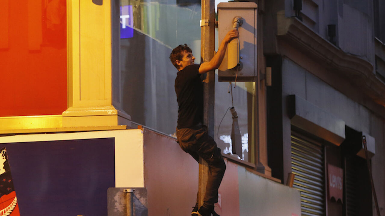 A demonstrator tries to destroy a CCTV security camera on Istiklal Street in central Istanbul July 13, 2013. Turkish police fired water cannon and tear gas on Saturday to disperse hundreds of protesters who gathered to march to Gezi Park, which has been at the heart of fierce unrest against Prime Minister Erdogan's rule. Protesters scattered, running into sidestreets where police pursued them, before starting to regroup on Istiklal Street, metres from the main Taksim Square. REUTERS/Umit Bektas (TURKEY - Ta