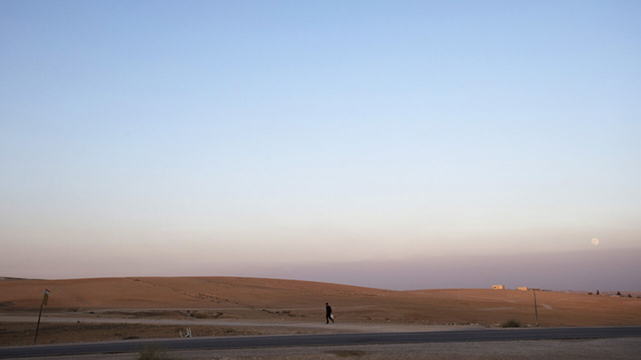 A man walks near the village of al-Sira, one of dozens of ramshackle Bedouin Arab communities in the Negev desert which are not recognised by the Israeli state, in southern Israel August 20, 2013. For decades Arab Bedouins have eked out a meagre existence in the Negev desert, largely under the Israeli government's radar, but now many will have to make way for new developments. Israel has already invested around $5.6 billion to build military bases in the Negev desert and plans to build 10 new communities th