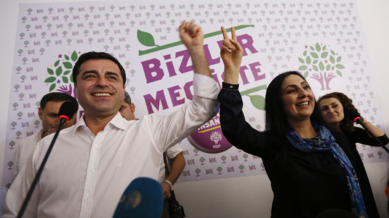 TURKEY-ELECTION/ Co-chairs of the pro-Kurdish Peoples' Democratic Party (HDP), Selahattin Demirtas (L) and Figen Yuksekdag celebrate inside party's headquarters in Istanbul, Turkey, June 7, 2015. Partial results from Turkey's parliamentary election on Sunday put the ruling AK Party on 43.6 percent of the vote, with just under two-thirds of ballots counted, a level which could leave it struggling to form a single-party government. The results, broadcast by CNN Turk, put the pro-Kurdish Peoples' Democratic Party (HDP) at 10.6