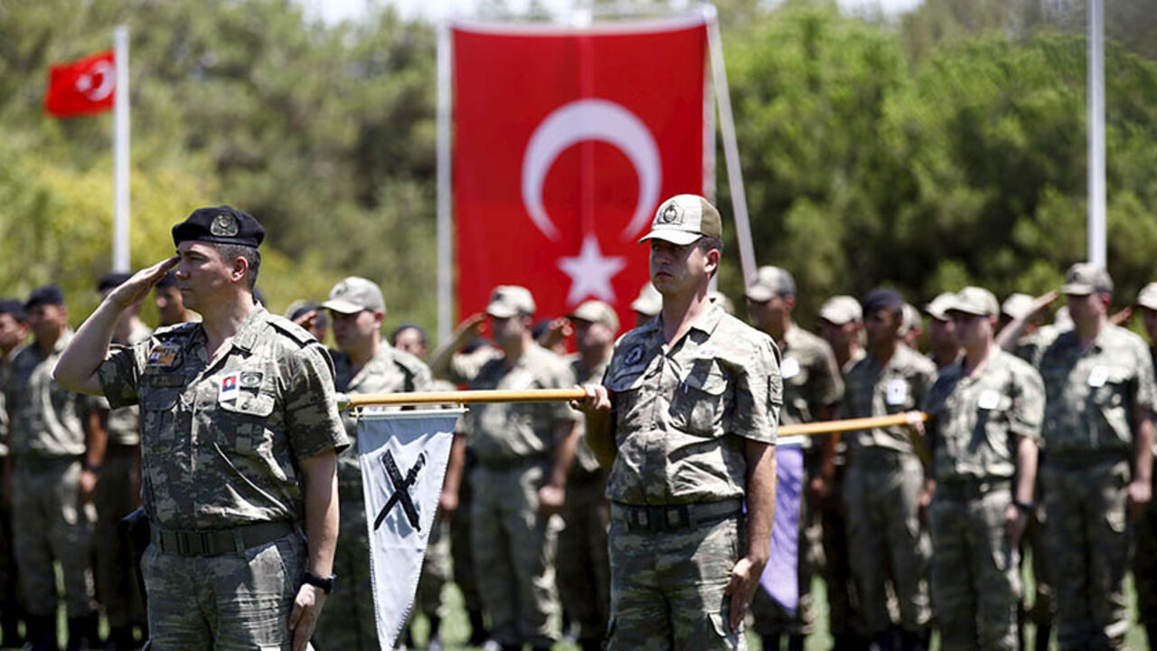 Turkish soldiers stand at attention during a ceremony for their comrade Mehmet Yalcin Nane who was killed by Islamic State militants on Thursday, at a military base in Gaziantep, Turkey, July 24, 2015. Turkish warplanes pounded Islamic State targets in Syria and police detained hundreds of suspected militants across Turkey on Friday, a sign that Ankara may have shed its hesitancy in taking a front-line role against jihadist fighters. Turkey has long been a reluctant partner in the U.S.-led coalition against
