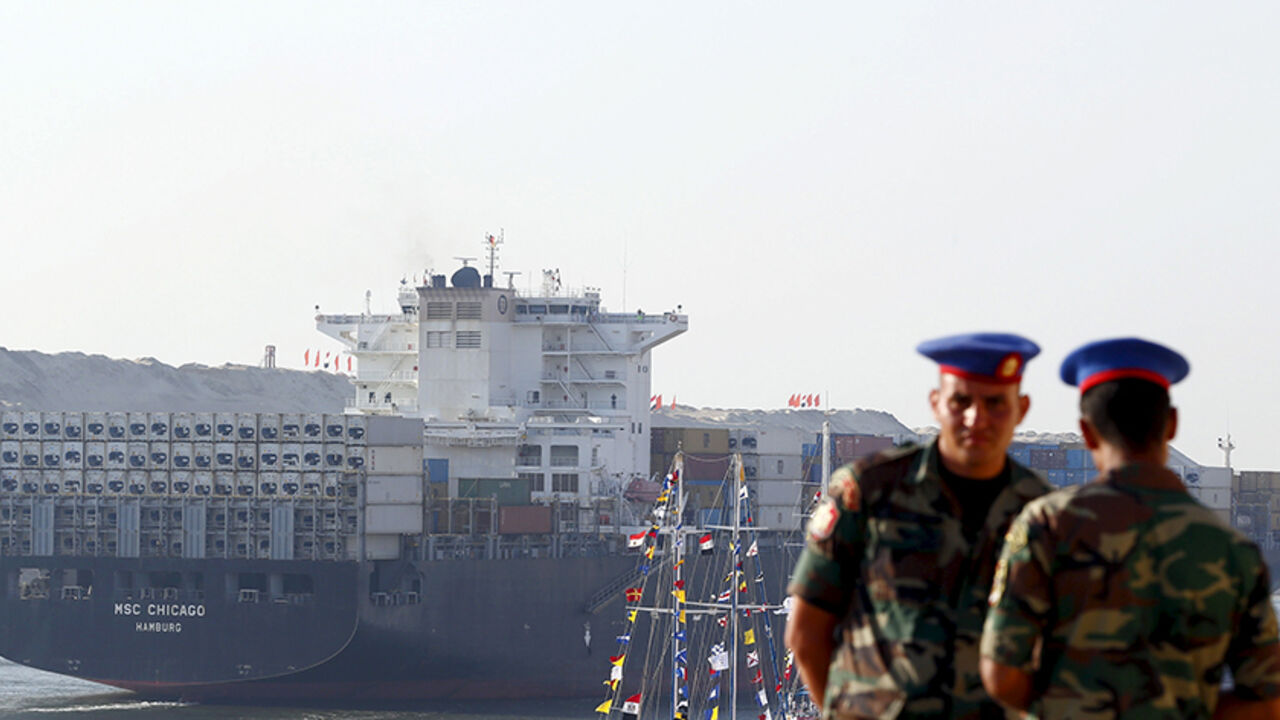 EGYPT-SUEZCANAL/ Egyptian Republican Guard stand guard, as a cargo container ship crosses the new section of the Suez Canal after the opening ceremony of the new Suez Canal, in Ismailia, Egypt, August 6, 2015. Egypt staged a show of international support on Thursday as it inaugurated a major extension of the Suez Canal which President Abdel Fattah al-Sisi hopes will power an economic turnaround in the Arab world's most populous country. REUTERS/Amr Abdallah Dalsh REUTERS/Amr Abdallah Dalsh - RTX1NCNP