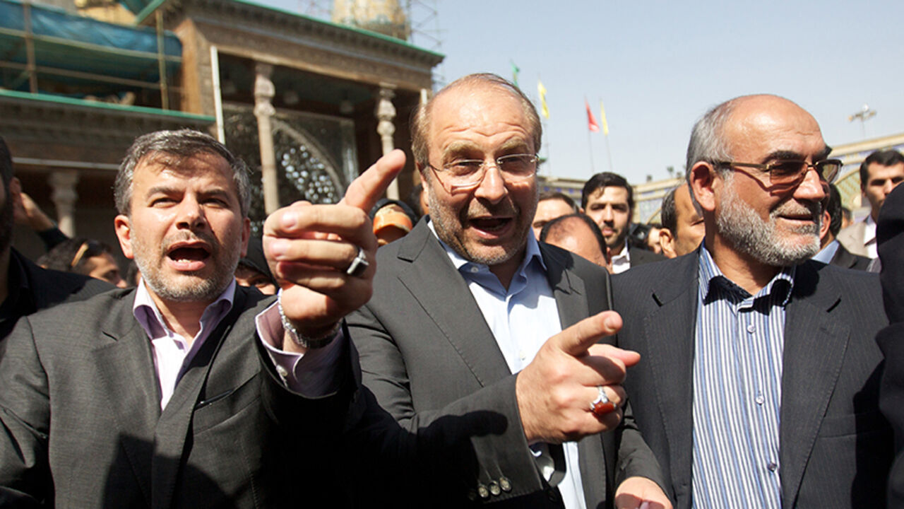 Nic6224646 Tehran's mayor and presidential candidate, Mohammad Baqer Ghalibaf (C) arrives to vote in the first round of the presidential election on June 14, 2013 at a polling station at Shah Abdolazim mausoleum in southern Tehran. Iranians are voting to choose a new president in an election the reformists hope their sole candidate will win in the face of divided conservative ranks, four years after the disputed re-election of Mahmoud Ahmadinejad. AFP PHOTO/BEHROUZ MEHRI (Photo credit should read BEHROUZ MEHRI/