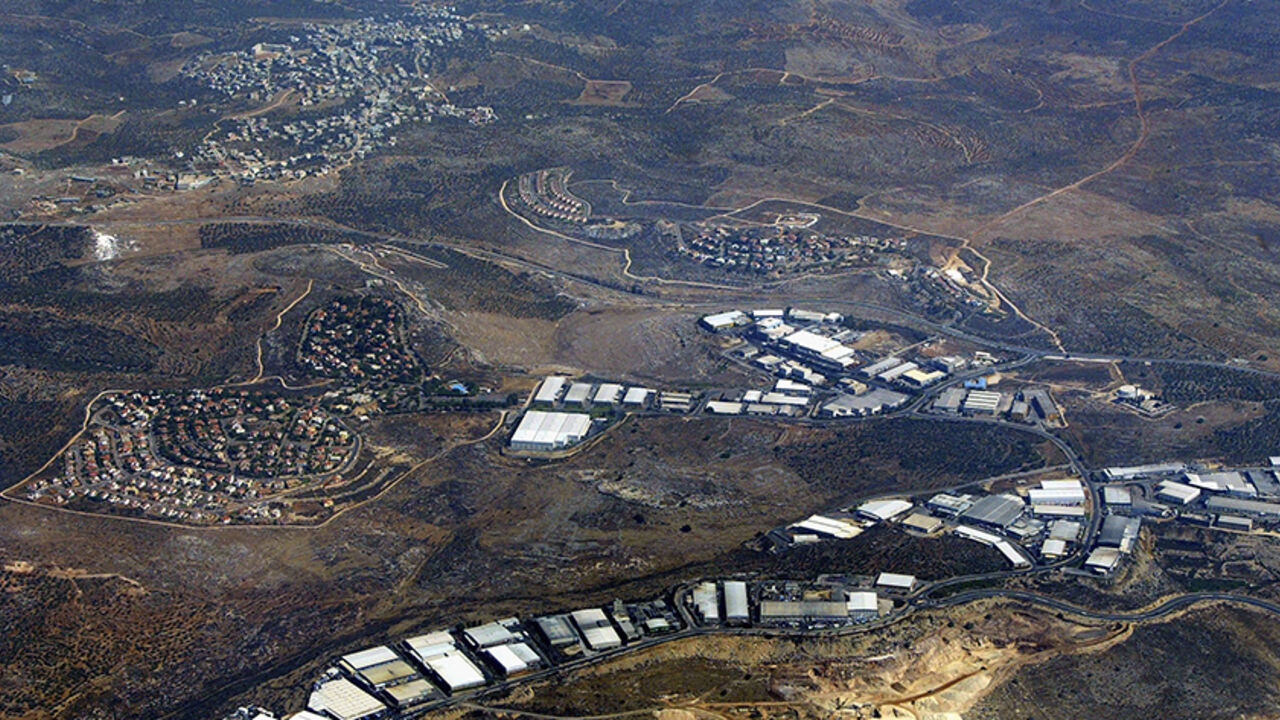 51125419DS013_settlement BARKAN, WEST BANK - JULY 30: The Israeli settlements of Barkan (left) and Kiryat Netafim (center) separate the Palestinian village of khirbet Bani Hassan (top left) July 30, 2004 from the of the West Bank settlement industrial area of Barkan (below). According to the left-wing Israeli movement Peace Now, some 230,000 Israelis live in 145 settlements in the West Bank and Gaza Strip, not including the scores of illegal outposts which Israel had promised the United States it would dismantle. (Photo by David Si