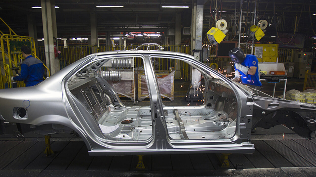 IRAN-CARS/ An Iranian worker works on a production line of carmaker Iran Khodro, west of Tehran June 20, 2011. Unusually for the Middle East, Iran has developed its domestic car industry for five decades and produced 1.6 million vehicles last year, about half of them made by Iran Khodro which aims to export around 10 percent of its production this year. Even with sanctions, which have scared off some suppliers from exporting to Iran, and a limp economy, Iran Khodro says sales rose 18 percent in 2010 and plans a 13 pe