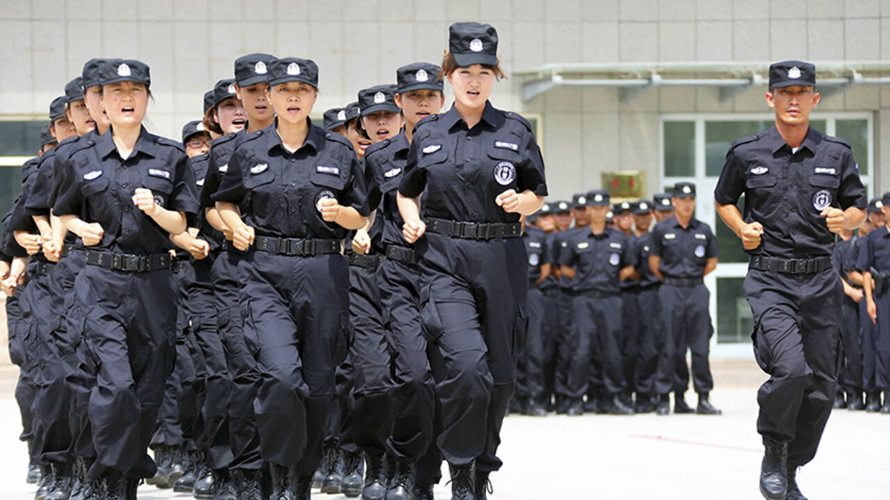 CHINA/ Policewomen from Special Weapons and Tactics (SWAT) team run in formation during a graduation performance after training as members of an anti-terrorist patrol team, in Hami, Xinjiang Uighur Autonomous Region June 29, 2014. Picture taken June 29, 2014. REUTERS/China Daily (CHINA - Tags: MILITARY CRIME LAW) CHINA OUT. NO COMMERCIAL OR EDITORIAL SALES IN CHINA - RTR3WKJW