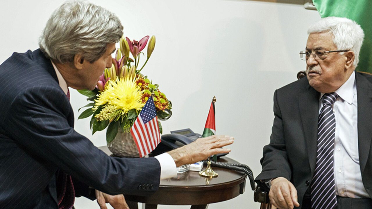 ISRAEL-PALESTINIANS/KERRY U.S. Secretary of State John Kerry (L) and Palestinian President Mahmoud Abbas talk at a meeting at the presidential compound in the West Bank city of Ramallah January 4, 2014. REUTERS/Brendan Smialowski/Pool (WESTBANK) - RTX171OW