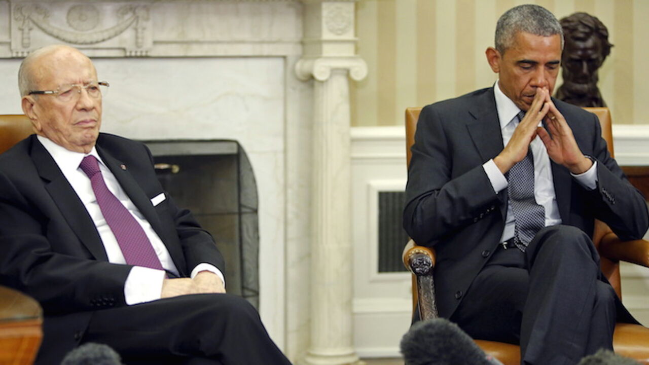 USA-TUNISIA/ U.S. President Barack Obama (R) and Tunisia's President Beji Caid Essebsi (L) listen to the translations as they deliver remarks to reporters after their meeting in the Oval Office at the White House in Washington May 21, 2015. REUTERS/Jonathan Ernst - RTX1DZY4