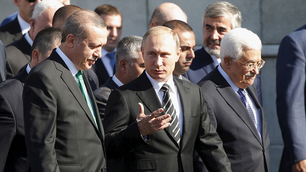 RUSSIA-RELIGION/ (R-L) Palestinian President Mahmoud Abbas, Russian President Vladimir Putin and Turkish President Tayyip Erdogan walk to attend a ceremony to open the Moscow Grand Mosque in Moscow, Russia, September 23, 2015. The new mosque, which was erected on the site of the city's original mosque built in 1904 and which has been under reconstruction since 2005, will be able to accommodate up to 10,000 people simultaneously, according to local media. REUTERS/Maxim Shemetov - RTX1RZOH