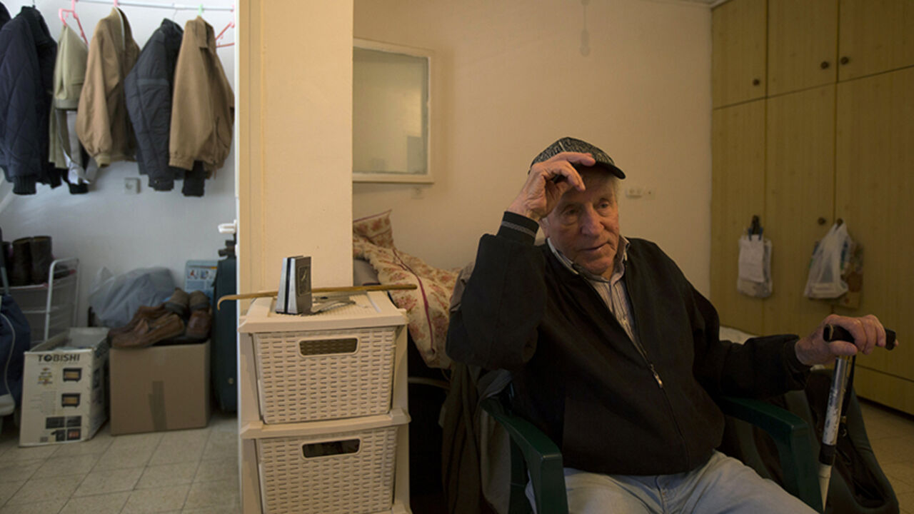 ISRAEL/ Transylvania-born Holocaust survivor Dov Yaacobovich, 84, sits in his home in Tel Aviv April 3, 2013. Some 192,000 Holocaust survivors live in Israel and about a third have sought aid from the Foundation for the Benefit of the Holocaust Victims in Israel. According to surveys by the foundation, 19 percent of the survivors have admitted to going without adequate amounts of food and 14 percent had to forego medical treatment at least once a year due to financial hardship. The report said that another severe c
