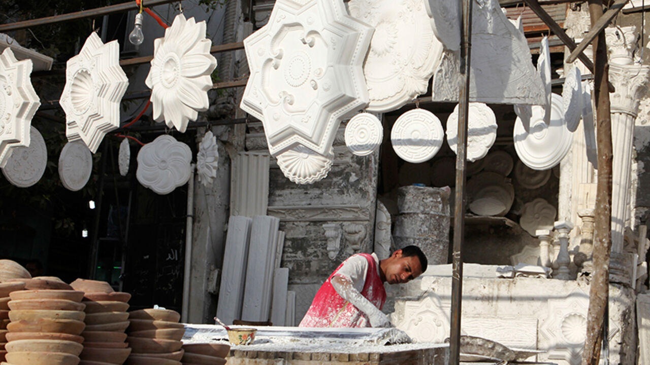 A worker makes decorative elements from plaster at an outdoor workshop in Cairo, February 26, 2013. Countrywide, the report estimates over 4,500 factories have shut since the revolution, swelling by hundreds of thousands the ranks of unemployed in a nation where two-fifths of the people live on or around the poverty line. The unemployment rate is around 13 percent, according to official data, but private analysts believe the actual rate is much higher. Picture taken February 26, 2013. To match story EGYPT-I