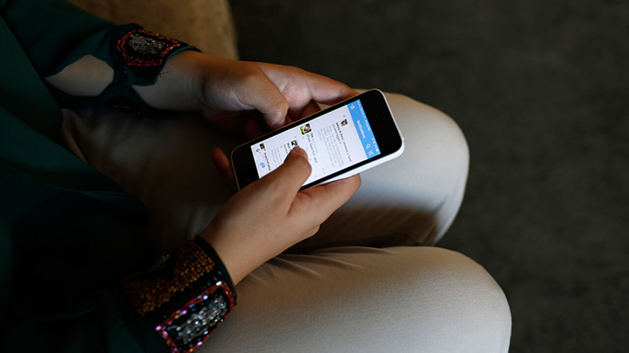MIDEAST-GAZA/TWITTER Farah Baker, 16, uses her phone to tweet in her family's home in Gaza City, August 10, 2014. As bombs explode in Gaza, Palestinian teenager Farah Baker grabs her smartphone or laptop before ducking for cover to tap out tweets that capture the drama of the tumult and fear around her. The 16-year-old's prolific posts on Twitter have made her a social media sensation through the month-old conflict. Once a little known high school athlete, Baker's following on the Web site has jumped from a mere 800 to a whoppi