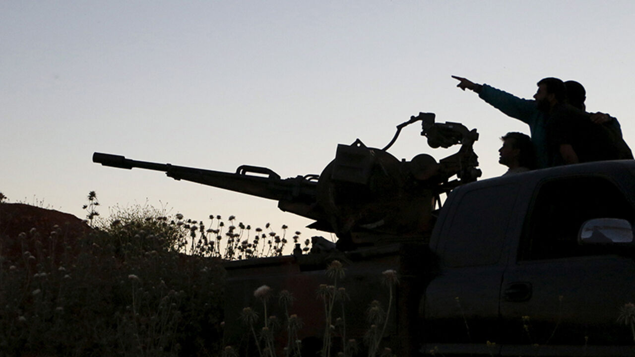 MIDEAST-CRISIS/SYRIA Tajammu Al-Ezza brigade fighters on an anti-aircraft weapon inspect the sky for helicopters loyal to Syria's president Bashar Al-Assad located in Hama countryside May 6, 2015. Picture taken May 6, 2015. REUTERS/Mohamad Bayoush
- RTX1BX2T