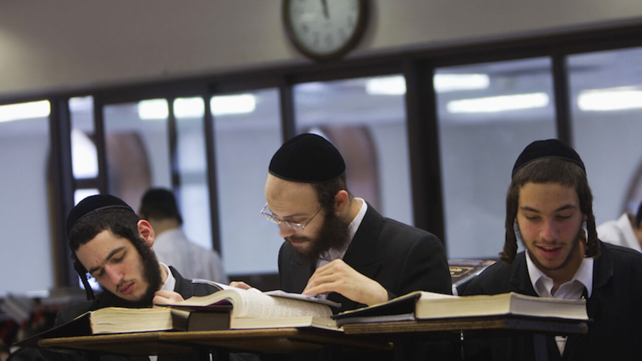 ISRAEL-ULTRAORTHODOX/ Ultra-Orthodox Jewish men study at Jerusalem's Mir Yeshiva, the largest Jewish seminary in Israel July 4, 2012. The ultra-Orthodox Jews have gone from being a tiny minority in Israel's mostly secular society to its fastest-growing sector, now about 10 percent of the 7.8 million population. They are exempt from military duty in Israel but draft deferments and state subsidies for the ultra-Orthodox have become a divisive political issue in Israel, where the government must decide a new law by August to ensure