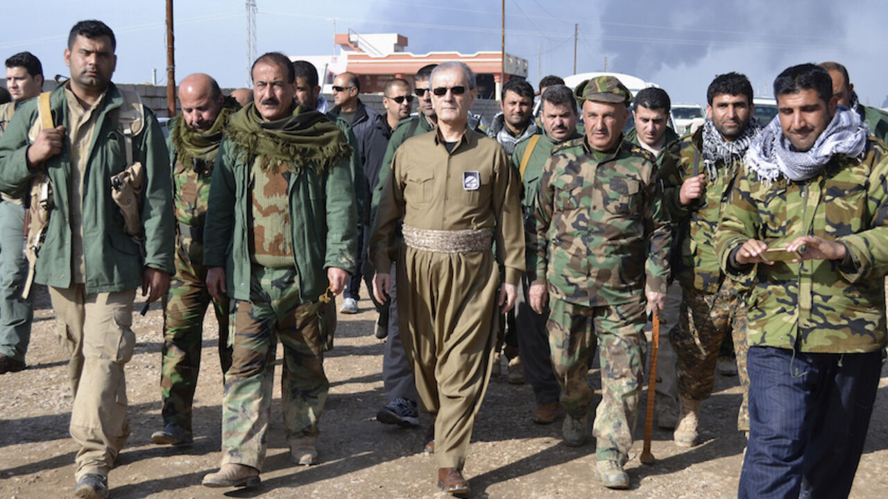 MIDEAST-CRISIS/IRAQ-OIL Kirkuk Governor Najmaldin Karim (C) walks with Kurdish peshmerga officers near Khabbaz oilfield, in the outskirts of Kirkuk February 1, 2015. Iraqi Kurdish forces on Sunday found and freed workers who had gone missing a day earlier when Islamic State insurgents seized a small crude oil station near the northern city of Kirkuk, the provincial governor and a provincial councilman said. Picture taken February 1, 2015. REUTERS/Stringer (IRAQ - Tags: CIVIL UNREST CRIME LAW POLITICS ENERGY CONFLICT) - RTR4NVVJ