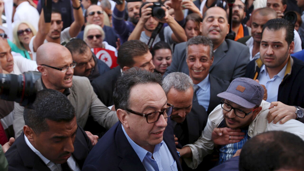 Hafhed Caid Essebsi, son of Tunisian president Beji Caid Essebsi, arrives for a meeting with leaders of the Nidaa Tounes party in Tunis, Tunisia Hafhed Caid Essebsi (C), son of Tunisian president Beji Caid Essebsi, arrives for a meeting with leaders of the Nidaa Tounes party in Tunis, Tunisia November 3, 2015. Tensions between two wings of Nidaa Tounes, whose name means Call of Tunis, spilled over into violence last week when a party meeting descended into open fighting with fists and sticks. A split within Nidaa Tounes could trigger political instability in the country that launched the first of the Arab Spring revolutions in 2011. Thirty-two of Ni