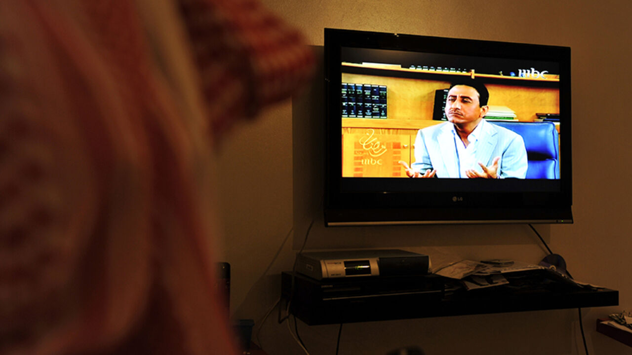 Nic484266 A Saudi man watches the most popular Saudi TV series during the holy fasting month of Ramadan "Tash Ma Tash" in the Red Sea port city of Jeddah on August 22, 2010. Turning the tables on conservative Islamic beliefs, "Tash ma Tash" has again sparked huge laughs and huge controversy this month by depicting a Muslim woman not just married to four husbands, but also wanting to divorce one of them in order to marry someone else. AFP PHOTO/AMER HILABI (Photo credit should read AMER HILABI/AFP/Getty Images)