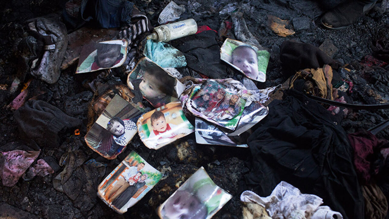 86450200 DUMA,WEST BANK - JULY 31: Family members and relatives of 18 month old baby, Ali Saad-Dawabsheh, view the remains of their house after a fire which was suspected to have been set by Jewish extremists on July 31, 2015 in the Palestinian village of Duma, West Bank. A house fire in the Palestinian village of Duma, West Bank, suspected to have been set by Jewish extremists, killed an 18-month-old Palestinian child, injured both parents and a four year old brother. (Photo by Oren Ziv/Getty Images)