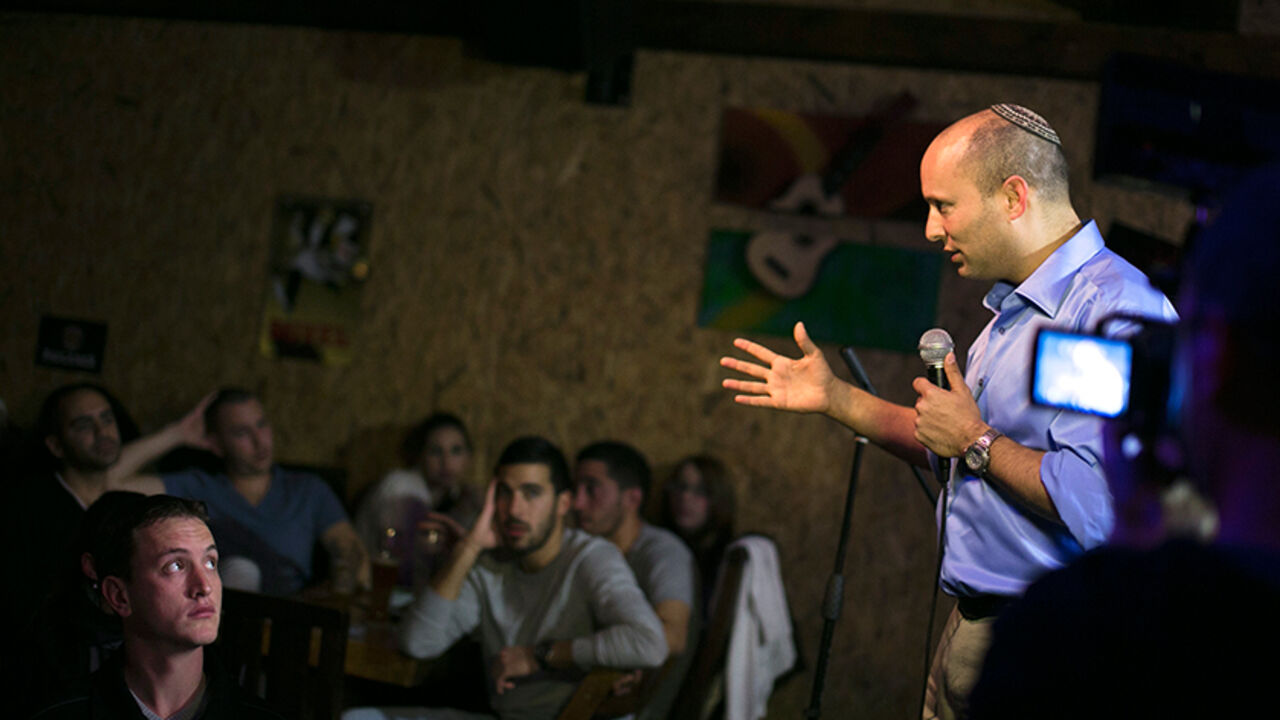 ISRAEL-ELECTION/BENNETT Naftali Bennett, head of the Beit Yehudi (Jewish Home) party, campaigns at a bar in the southern city of Ashdod December 27, 2012. A Palestinian state would be suicide for Israel, says Bennett, a high-tech millionaire who heads a far-right party whose popularity has been the surprise of the country's election campaign. Picture taken December 27, 2012. To match Interview story ISRAEL-ELECTION/BENNETT REUTERS/Amir Cohen (ISRAEL - Tags: POLITICS ELECTIONS) - RTR3C8SR