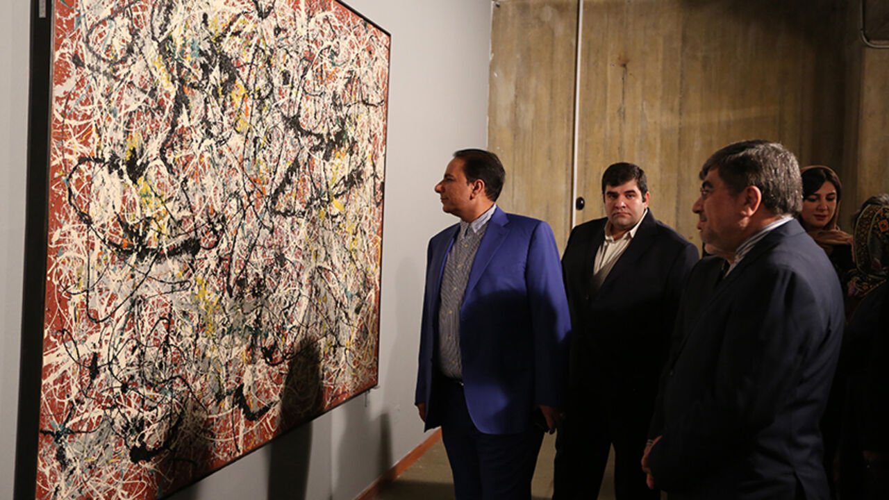 Nic6511555 TO GO WITH AFP STORY BY ARTHUR MACMILLAN
Iranian Culture Minister Ali Jannati (R) looks at US artist Jackson Pollock's "Mural on Indian Red Ground" (1950) during the opening ceremony of an exhibition of modern art at Tehran's Museum of Contemporary Art (TMOCA) in the capital, on November 20, 2015. Some of the world's most expensive and rarely seen modern art, including works by the Americans Jackson Pollock and Andy Warhol, which are part of a collection bought in the 1970s by dealers acting for Farah, the
