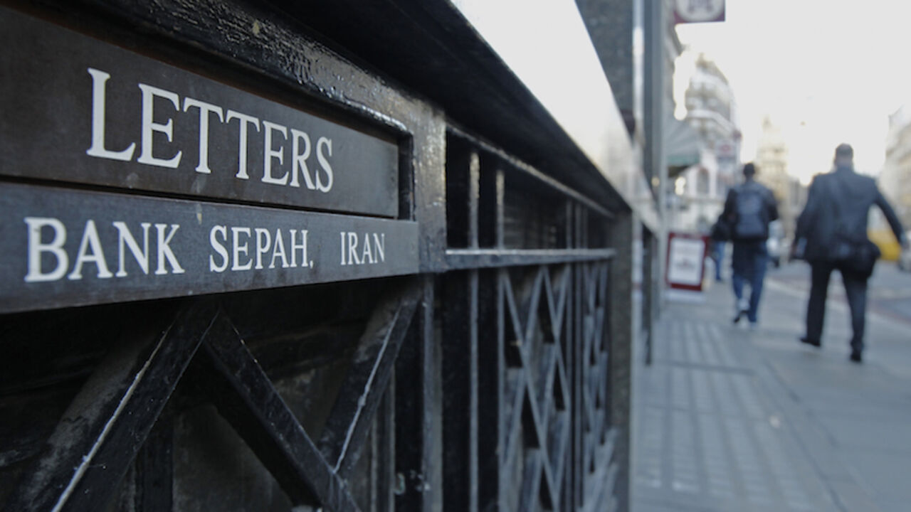 IRAN/BANKS-BRITAIN People pass the letterbox of Iranian owned Bank Sepah International in London December 22, 2011. Saderat is one of a handful of lonely Iranian banking outposts that have managed to hold out in Europe's financial hub despite escalating tensions with the West over Iran's nuclear programme. REUTERS/Luke MacGregor (BRITAIN - Tags: BUSINESS POLITICS) - RTR2VJUY